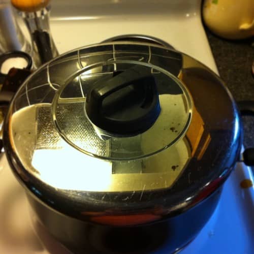 Make sure the lid seals well on your pot. Turning the temperature down will pull the lid on tighter and keep things cooking nicely. If your lid has a vent, close it.