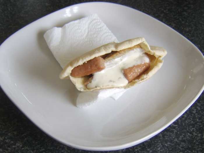 Refried turkey leg meat, mini sausages and ranch dressing are incorporated in a pitta bread sandwich