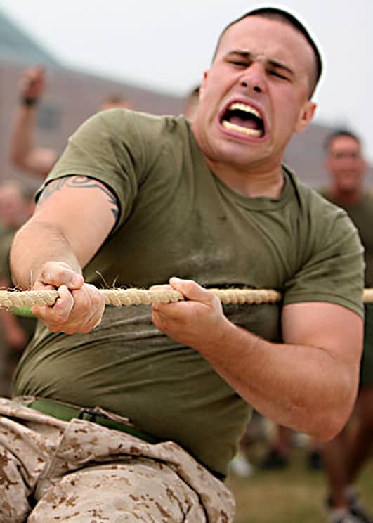 Tug of War as a form of tough, yet friendly competition, is popular with military forces. Here, Cpl. Joshua McDermott, of Combat Logistics Regiment 27, shows true grit and determination during one pull