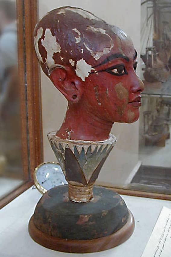 An ancient scupture of Tutankamun found in his tomb in Egypt. The head stands in a vase ornamented with the design of the Blue Lotus flower