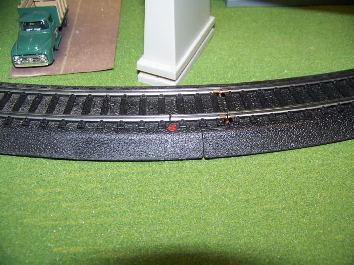 Sometimes, in both DC (Direct Current) and DCC (Digital Command Control) layouts, you have insulate track sections. I do this by cutting the track with a Dremel. Marking the spot with a red dot of paint will make it easier to find later.