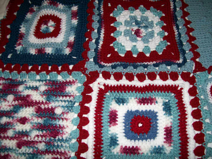 Scraps and leftover skeins can come together into something unique. Like this blanket made with squares of various patterns.