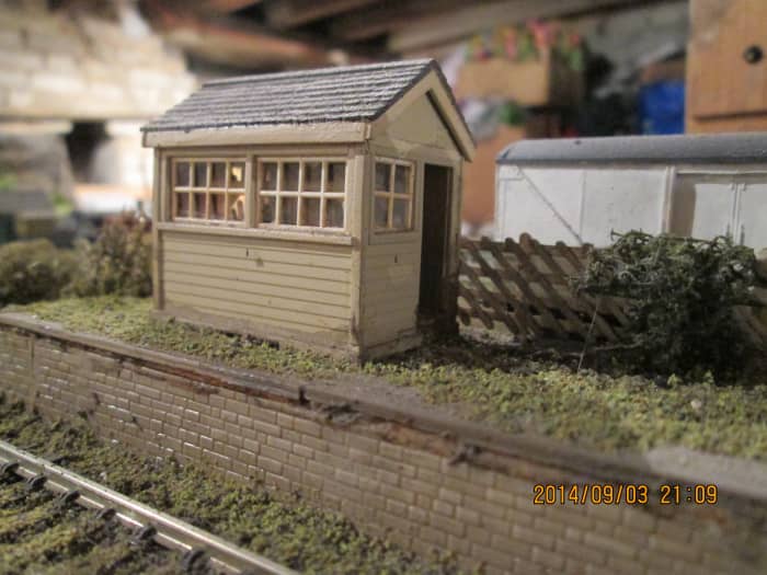 The signal cabin, door ajar, ready for the porter signalman to attend to the point-settings for when the branch pick-up goods comes, shunts and leaves again the way it came