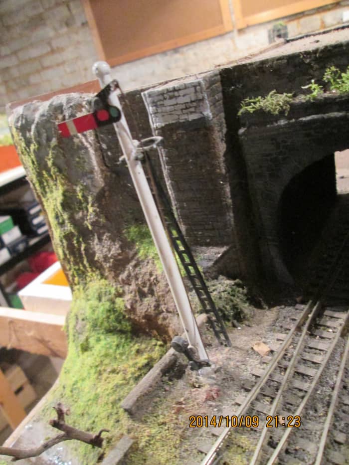 The Hornby starter signal at 'on' means a train could be due or the line is occupied - the tunnel entrance is boxed in to darken it, make it a touch more realistic