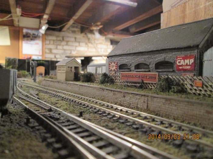 I utilised both plastic and metal elements on the goods shed. Etched brass louvred warehouse windows, moulded plastic walls and roof, plastic double doors with brass wire 'hinges' both ends, printed card 'enamel signs'.