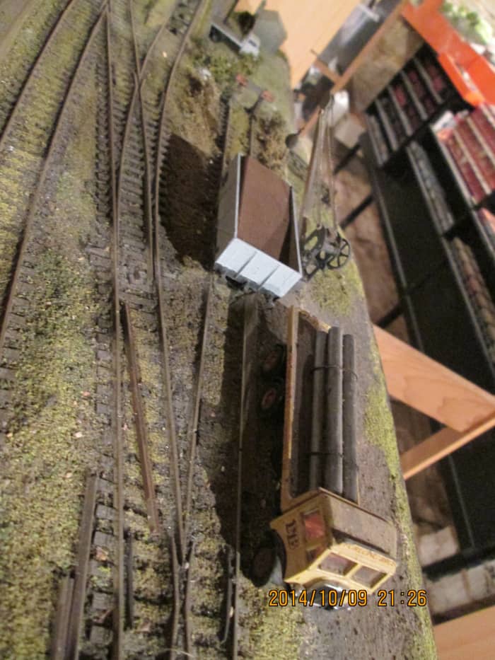 Looking down at the heavy lorry with pipe load (EFE Models' AEC Mammoth, Evergreen plastic tube ) by the crane by modified Parkside BR 13 ton open wagon (PC01A with unfitted wagon brakes replacing clasp brake sprue supplied) corrugated plastic 'load'