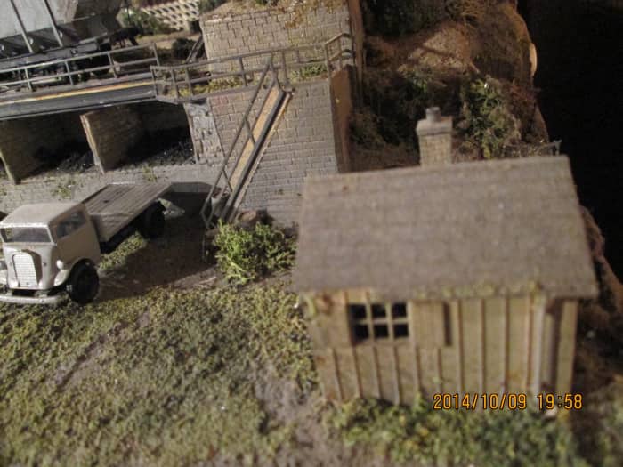 The old coal office with the steps up to the rail deck, a short flatbed lorry such as the one left would be used as a coal delivery vehicle (white metal kit with clear plastic 'glazing', built by supplier)