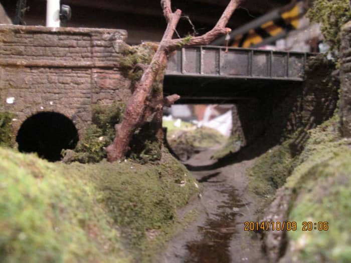 From the front, livestock underpass or 'cattle creep'behind that tree, the girder sidewall and abutments on the station side