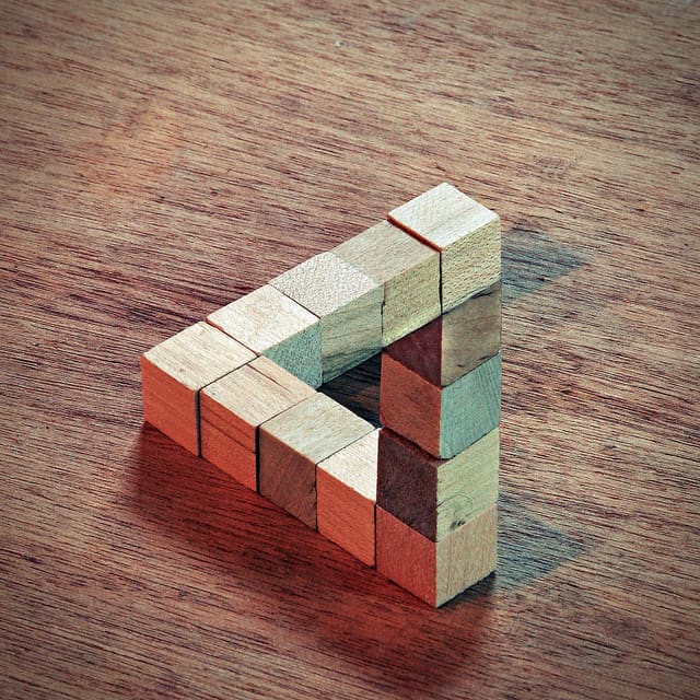 This visual illusion was created in photoshop. Built from wooden blocks, two images were combined digitally with crop and curve adjustment layers added to add to the illusion