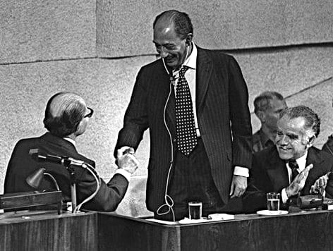 Israel Prime Minister Menachem Begin Shakes Hands with Egyptian President Anwar Sadat as Future Israel Prime Minister Yitzhak Shamir Applauds during Speech before Israel Knesset, November 19, 1977