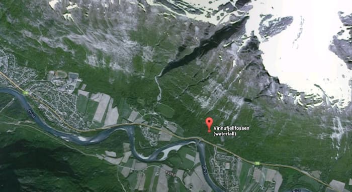 Vinnufossen Falls are located in Norway starting at the top of a very steep cliff side of a large mountain ending in a valley below. This waterfall is located just above the marker in the picture where the snow starts on the mountain top.