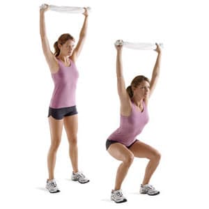 Performing the overhead squat with a towel. Note that the arms are lined up over the shoulders and hips.
