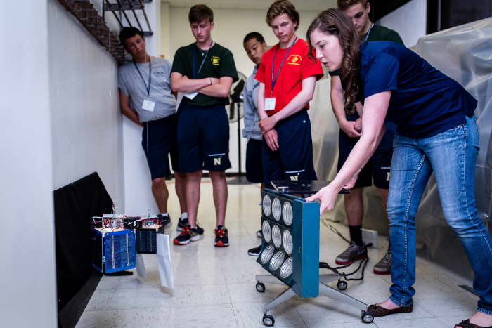 Students learn about the physics of heat on satellites.