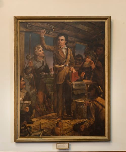 This painting, by Henry Arthur McArdle, shows Stephen Austin rallying the colonists. The mysterious Baron de Bastrop is listed as the man in the lower left corner.