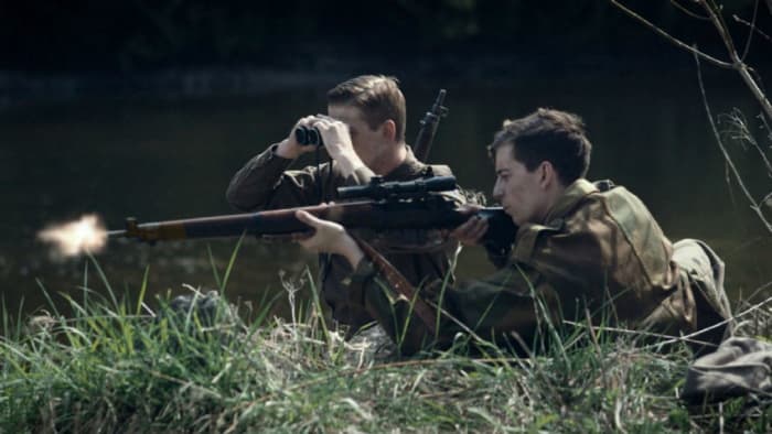The Canadian regiment of the Black Watch - they were first over the Rhine in 1945 - re-enacts a WWII Normandy scene with rifleman and spotter to confirm his 'hit'