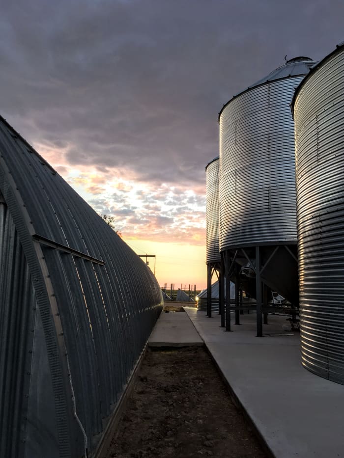 This job site has two completed bins on hoppers, plus one bin ready to be set, and another under construction.