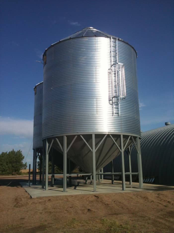 This brand new bin and hopper has been built, anchored, and sealed. A few details have yet to be completed.