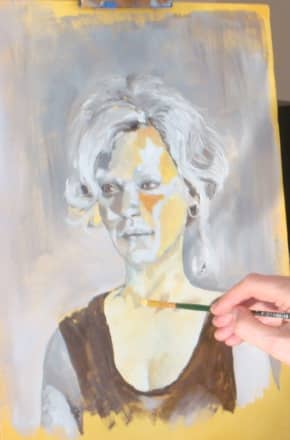 This is an artist in action, painting from a live model. the canvas has been washed in acrylic paint in Raw Umber and she is painting oil paint in a grey scale, (grisaille) to map out all of her shapes. When this part is finished, if the model isn'