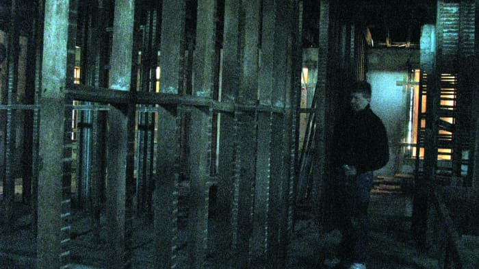 This is a strange photograph. I did NOT change the color of it in photoshop... all I did was enhance the brightness of it. The flash in my camera did not go off. This is Jon standing on the second floor with I believe to be a shadow figure behind