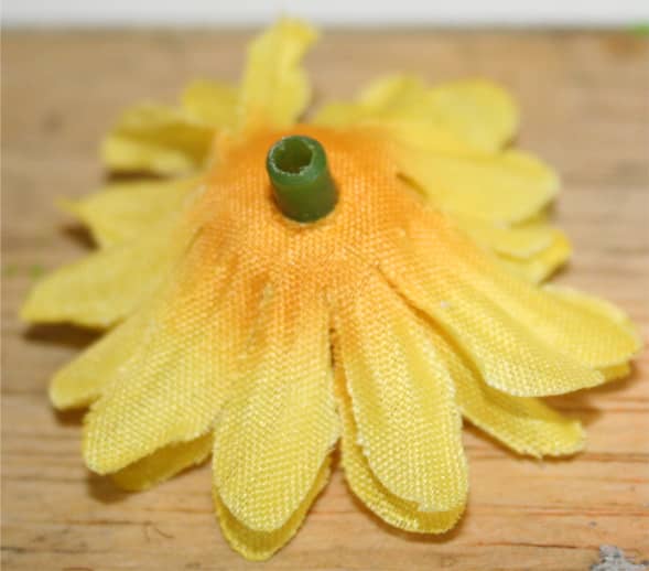 This photo shows that I've removed a plastic green piece. After this photo was taken, I cut off most of the stem and then put a small amount of hot glue where the stem and yellow material meet.