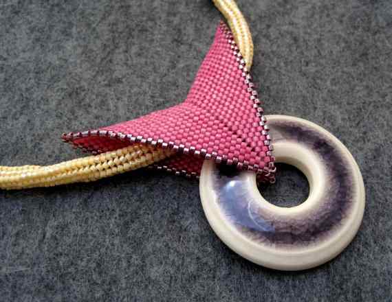 Tubular herringbone rope with a peyote bail and a ceramic donut focal.