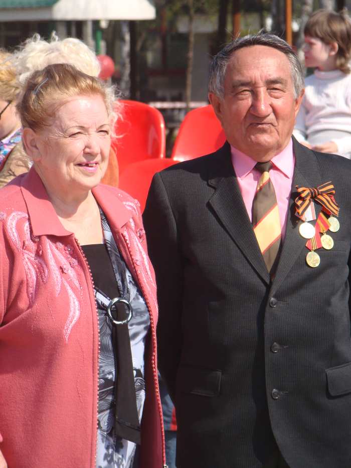 A Russian man and woman begin to remember the dead of World War II, the Great Patriotic Day celebration and holiday