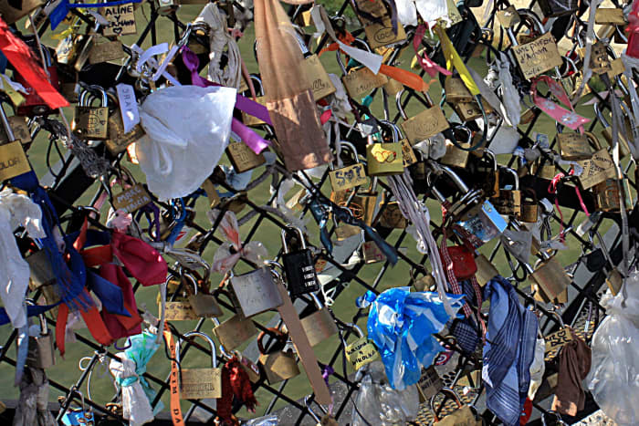 Padlocks and symbols of everlasting love on Le Pont des Arts, as described in the text. This is a pleasing tradition; there isn't room for many more padlocks, but hopefully a way will be found to allow the practice to continue