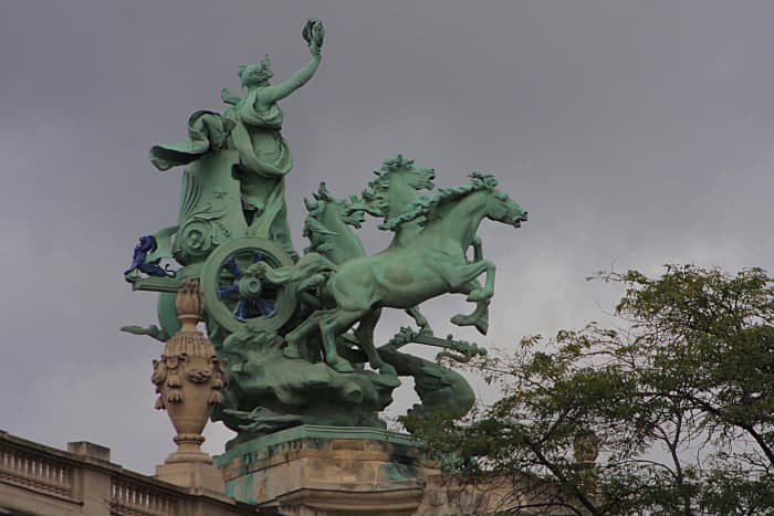 'Immortality outstripping Time' One of two copper sculptures by Georges Récipon which sit atop the northeast and southeast corners of the Grand Palais