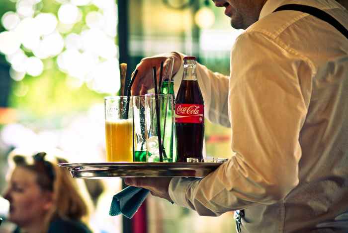 Those who think tips are something extra do not realize the level of training a preparation required to be a good service representative, no matter what the industry. Here, a waiter serves chilled drinks in Paris.