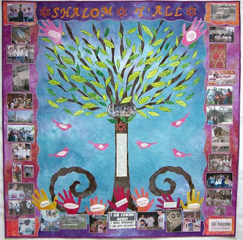 This quilt by Susan Schrott uses photo transfer, appliquéd and printed words, and appliquéd leaves, birds, hands and other motifs.