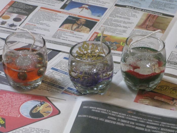 Fill the candle-holders with molten gel wax and allow it to harden for 10 minutes before lighting the wicks.