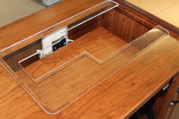Plexiglas inserts are custom made to fit sewing machines. Sewing machines can be upgraded and used in the same cabinet.