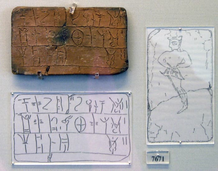 Tablet is inscribed in Linear B. The tablet comes from the House of the Oil Merchant. The tablet contains a register of an amount of wool to be dyed.