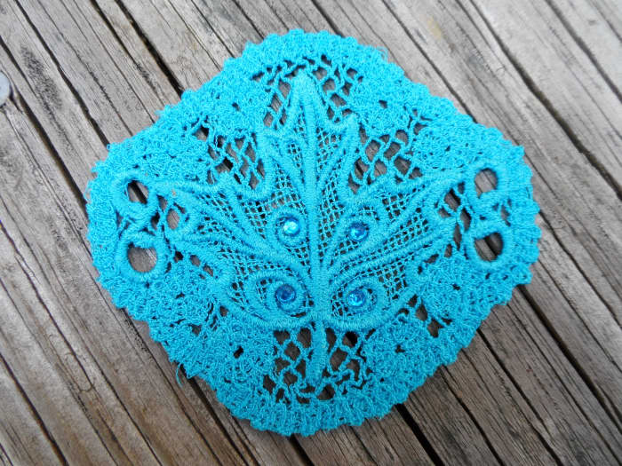 A hair piece, meant to be used with a hair stick, done using Sulky lace. From the "Evenfall" collection by Urban Threads