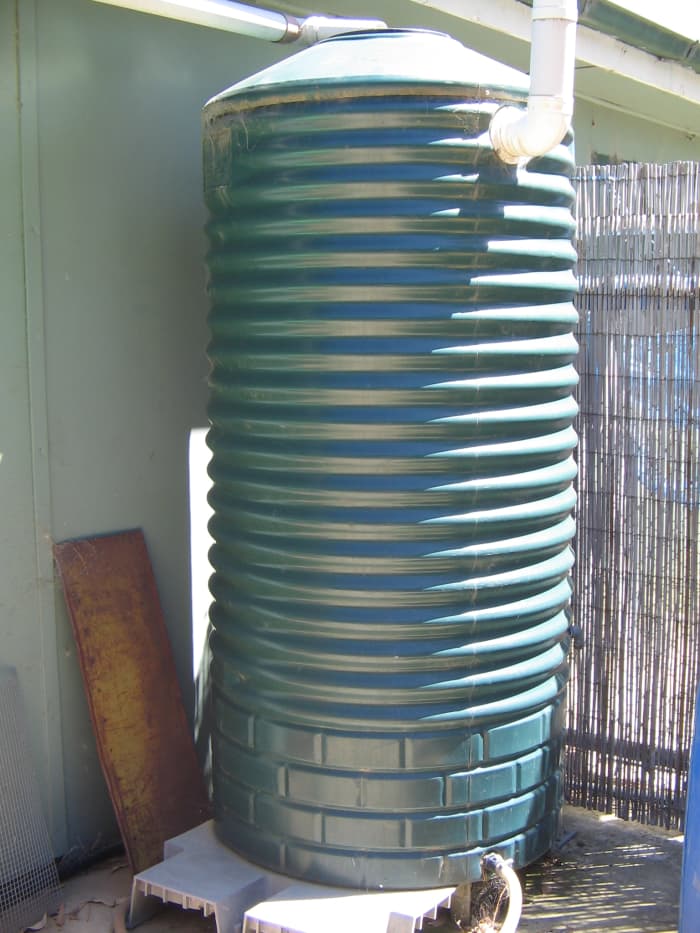 Poly water storage tank 220 gallon or 1000 liters, constructed to fit in garden setting and look like old fashioned tank.