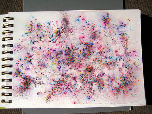 This pretty background is made by scattering watercolour pencil shavings over a water saturated page.