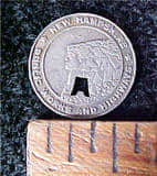 This is an example of the New Hampshire transportation coin that shows the "Old Man in Mountain," the state symbol.