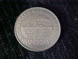 This is a commemorative coin for the "Norway" cruise ship which was damaged in a fire in 2003. The Norwegian Caribbean Lines ship will not sail again.
