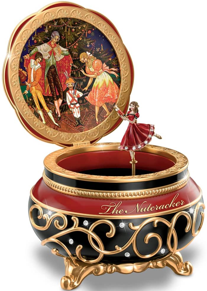With the turn of a key, a fully sculpted figure of Clara twirls around as the "Dance of the Sugar Plum Fairy" plays.