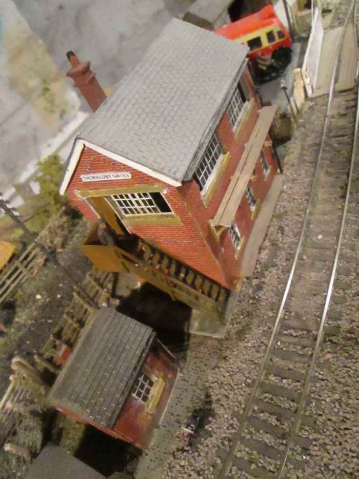Looking down on the gate cabin roof. Window frames are sliding North Eastern type, D&S etched brass, as also supports for cabin-front walkway, (half-etches bent to support the painted plastic 'planking'). Crossing gates are Ratio, planking is Wills'