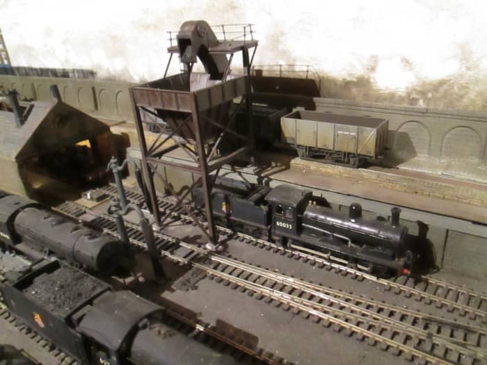 Looking the other way, with a Class J21 awaiting its turn under the post-WWII coaler - beyond that is the open end of the decrepit, war-damaged loco shed. An ash pit has since been added on the middle road (Peco Inspection Pit)