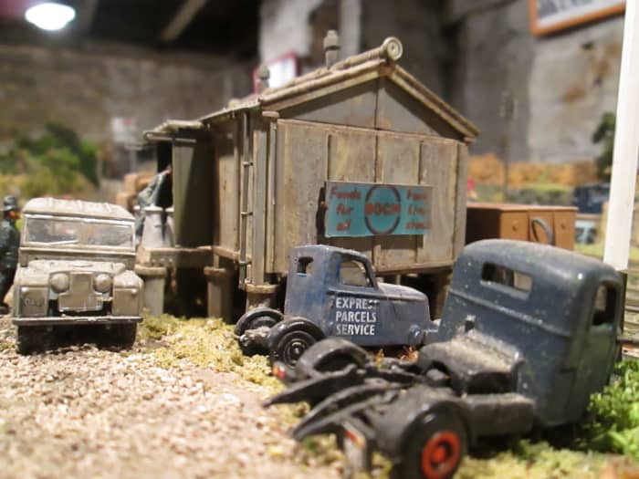 Provender stores replaced decrepit or burnt-out goods sheds to provide storage for animal foodstuffs or farm supplies with access for returned milk churns. Ratio kit painted and weathered with BOCM hoarding this end, Silcock's at front (later merged)