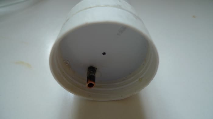 The cover of the extract container with the siphon peeping through. At the top you see how the air vent is constructed. I drilled a hole partially in the lid. It appears to be simple and very effective.