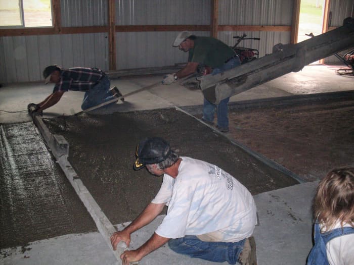 They go over the slab several times, giving more attention to some places than others. Holes or dips are filled in with shovelfuls of concrete, or a drag is used to move concrete from high spots into low ones.