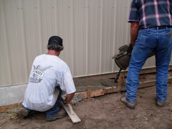 Holes are drilled for extra stabilization of the ground next to the building, as runoff is heavy here.