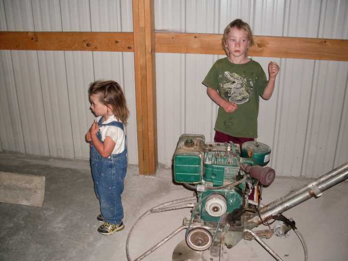 For starters, the kids were instructed to stay on the sidelines, and observe. That is a power cement trowel next to them. The building had been partially floored on a previous day.