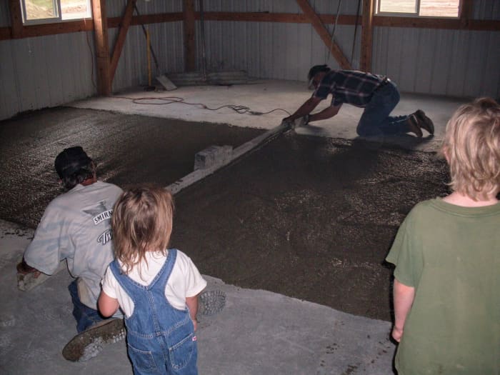 The men don't have to use a lot of muscle with this screed, as it is a power screed, and shakes the concrete into place. But they do need to be watchful and consistent, or the concrete may wind up slightly humpy.