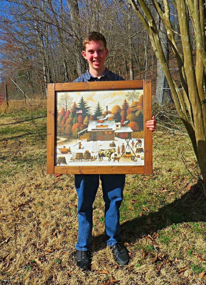 Grantley Waters and his finished and framed primitive folk art puzzle by Charles Wysocki, the Sugar Spigot, from our maples to your tables ... he made the frame himself from wood in the barn, hand sanded and stained, 1000 Piece ...