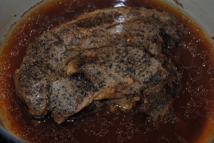 A beef chuck roast just out of the oven. The juices in the pan are all from the roast, generated during cooking. No other liquids were added - or needed.