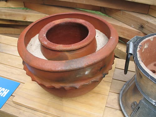 Passive cooling using a zee or zeer pot is accomplished with a double walled vessel made of bisque ware of earthenware the space between the pots is filled either with water of damp sand, A lid (not shown) keeps it cool inside. These can be large